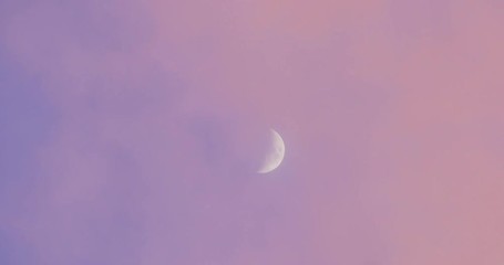 Beautiful waxing crescent moon pink sunset clouds blue sky background. 4K UHD - Powered by Adobe