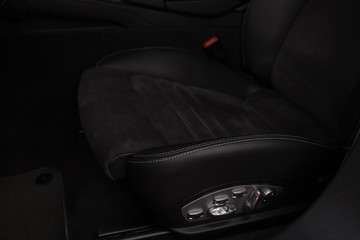 Black leather seat in sport car. Interior detail.