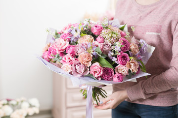 beautiful luxury bouquet of mixed flowers in woman hand. the work of the florist at a flower shop.