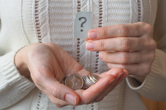 Arabic coins of dirhams in his hand and a question mark.
