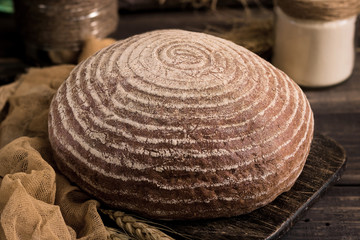 Fototapeta na wymiar Bread without yeast on a dark rustic background