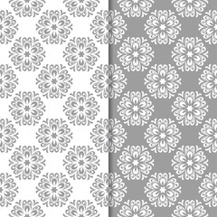White and gray floral backgrounds. Set of seamless patterns