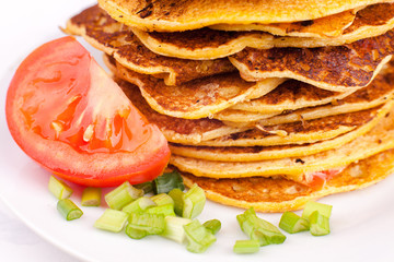 fried pancakes or fritters are stacked - a traditional dish for carnival, a serving option