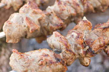 Mutton shish kebabs on skewers on the grill outdoors