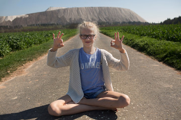 Yoga with a white hill behind 