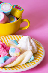 marshmallows of coloress on pink background
