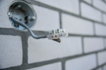 Electrical cables stick out of the wall