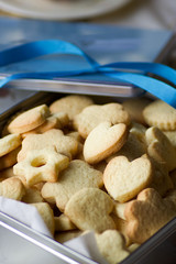 close up of pastry biscuits in a metal box, vertical