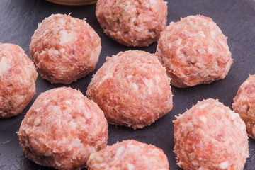 Fresh raw meat balls with dark background close-up