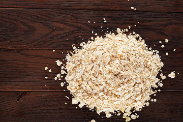 Healthy eating concept. Dry rolled oatmeal on wooden table