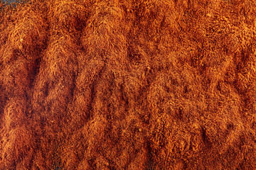 Texture background. Red chilli pepper powder. Top view