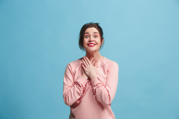 Beautiful woman looking suprised isolated on blue
