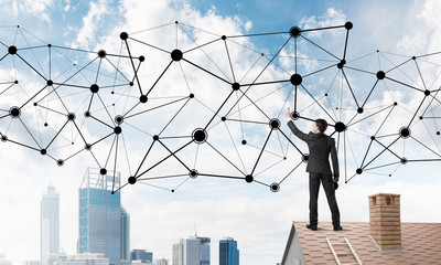 Businessman on house roof presenting networking and connection concept. Mixed media