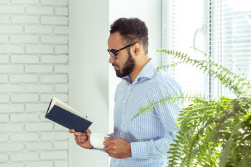 black man holding a book