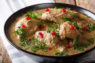 Caucasian cuisine: Satsivi with chicken and pomegranate close-up in a bowl on the table. horizontal