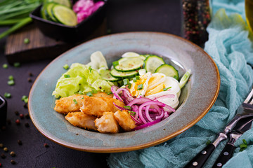 Salad from eggs, fried fish and fresh vegetables. Asian cuisine.