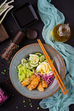 Salad from eggs, fried fish and fresh vegetables. Asian cuisine. Top view