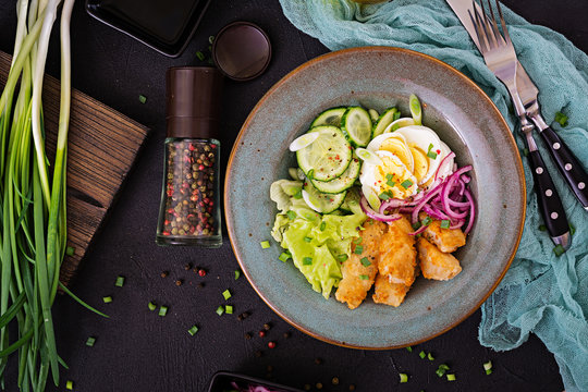 Salad from eggs, fried fish and fresh vegetables. Asian cuisine. Top view