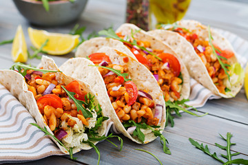 Mexican tacos with beef, beans in tomato sauce and salsa