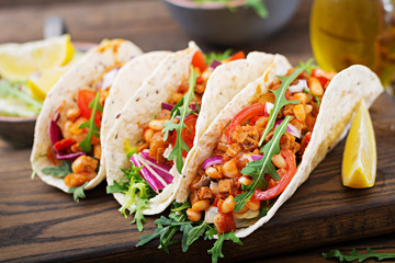 Mexican tacos with beef, beans in tomato sauce and salsa