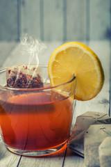 cup of tea with lemon on wooden table 