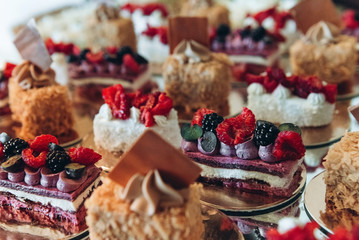 Beautiful cake on wedding candybar table with berries