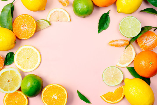 Citrus fruits frame on pink background