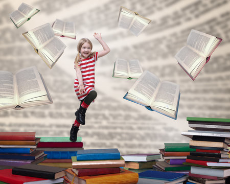 Happy child jumping out of the books