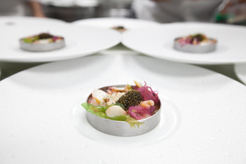 Chef cooking food with Caviar and shrimp for dinner party in the restaurant kitchen.
