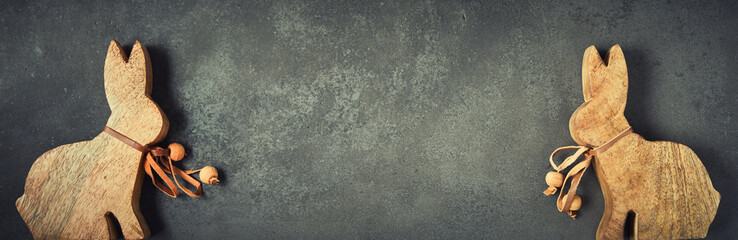 Cute Easter background with little wooden bunnies