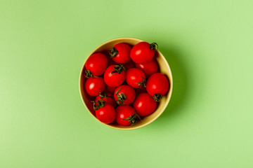 Tomatoes on a green pastel background