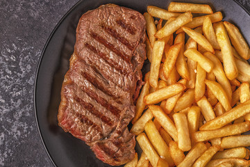 Beef barbecue steak with french fries.