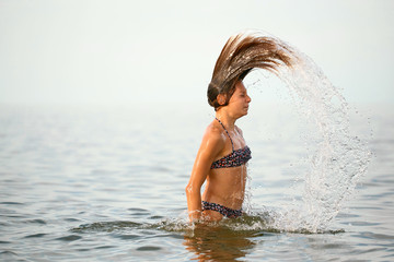 Girl with wet hair in the sea.