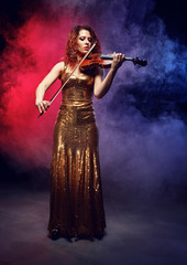 Violinist girl performs on stage.