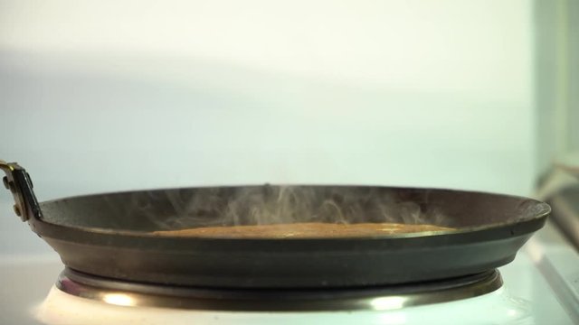 steam from the food in the frying pan