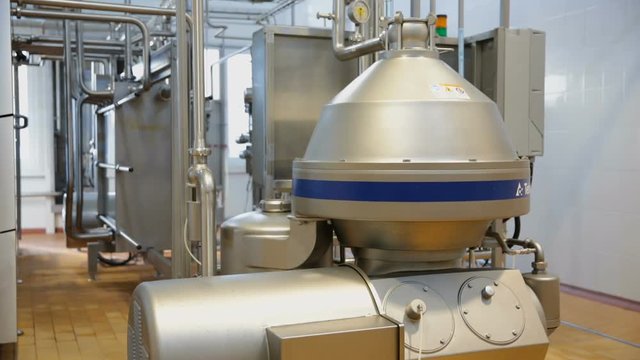 Production tanks, storages at dairy. Pipeline at dairy factory. Modern complex industrial industrial pasteurizing and cooling equipment. Equipment for cleaning milk. Equipment at dairy plant.