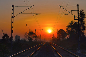 Fototapeta na wymiar Golden railway tracks at sunrise