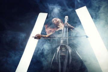 The cellist girl performs on stage.