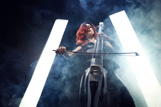The cellist girl performs on stage.