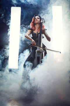 The cellist girl performs on stage.
