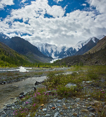 Beautifull valley with view to mountains, river and flowers