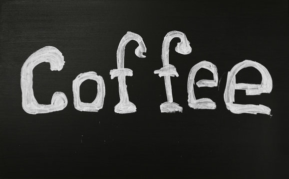 White chalk COFFEE word over black chalkboard
