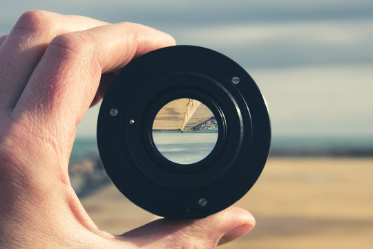 A concrete pier, the sea and the sky  through a camera lens - image inside is inverted, concept of summer vacation