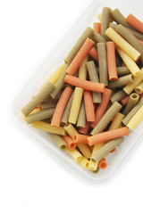 Variegated italian pasta isolated on white background. Colorful dried pasta