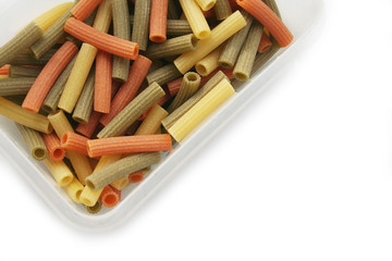 Variegated italian pasta isolated on white background. Colorful dried pasta