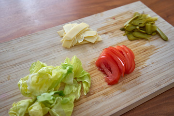 Ingredients For Garnishing a Hamburger Including Tomato Pickles
