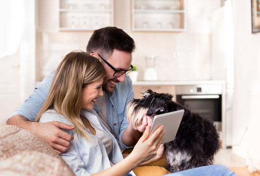 Young couple looking at tablet at home