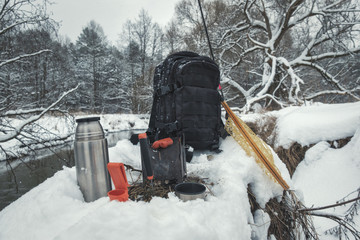 A picnic on a fishing trip, on a snow-covered winter river.