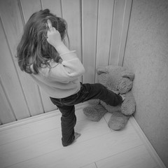 kick feet to beat a toy bear, girl, child