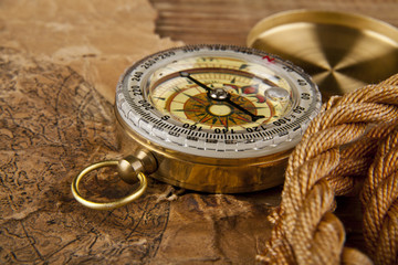 old paper, rope and compass on a wooden table